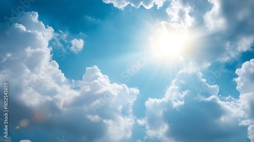 Fototapeta Naklejka Na Ścianę i Meble -  Bright sunlight shines through fluffy clouds, creating soft focus effect with subtle sun flares. serene blue sky evokes sense of peace and tranquility .