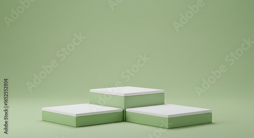 Three stacked square podiums with white tops on a muted green background
