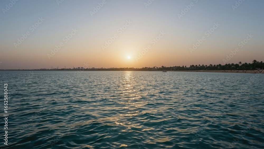 Obraz premium Morning light over coastal waters with a sandy shore