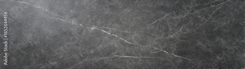 Dark honed soapstone with fine white mineral streaks and subtle textured stone surface