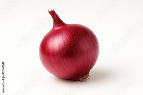 Single fresh onion displayed against a white backdrop