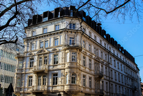 sand-colored stucco-clad building in Freiburg is illuminated by the winter sun
