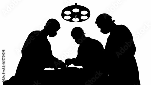 Silhouette of surgeons performing an operation under surgical lights in a hospital operating room setting
