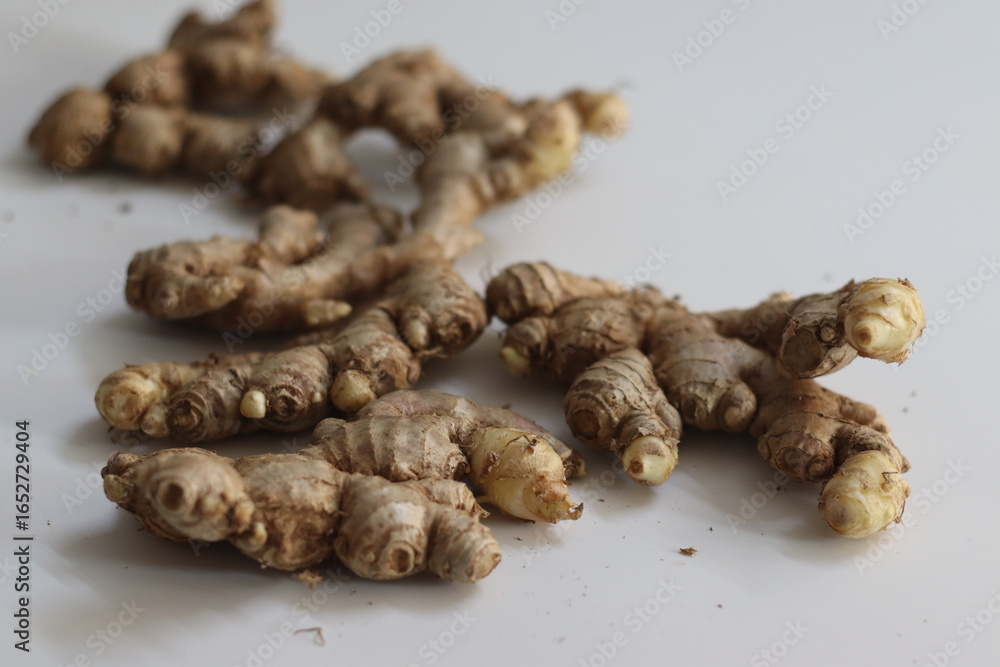 Ginger roots with knobby texture and peeled skin, symbolizing Indian cooking, healing, and wellness Ginger roots with knobby texture and peeled skin, symbolizing Indian cooking, healing, and wellness