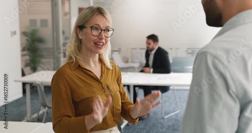 Two professionals shaking hands standing in modern corporate meeting office, respectful gesture of successful agreement, partnership and mutual understanding. Business collaboration, trust, services