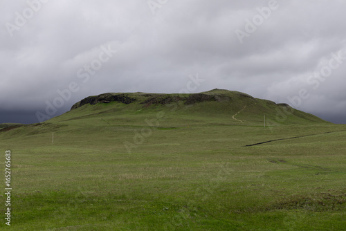 Εκτύπωση καμβά Green hill view with overcast sky in Iceland.