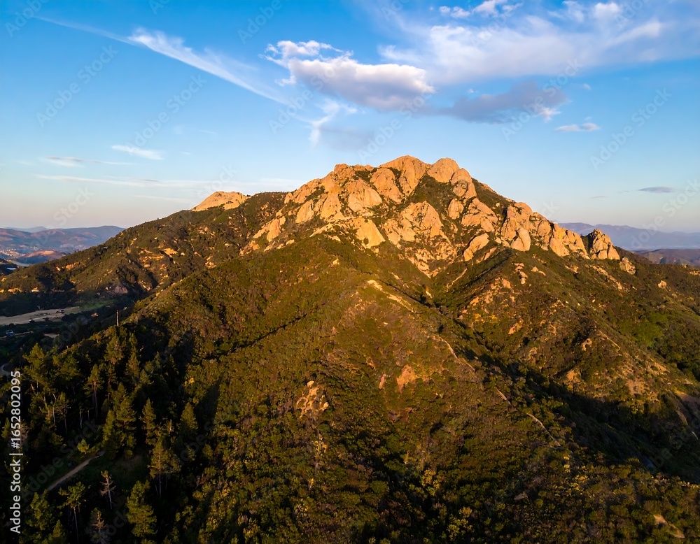 Fototapeta premium Picturesque mountain range with lush greenery and rugged rock formations scenery