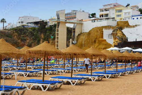 Tourism during the summer swimming season on the beach with shade and sunbeds