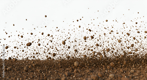 Brown Dirt and Soil Particles Suspended in Air Against a White Backdrop