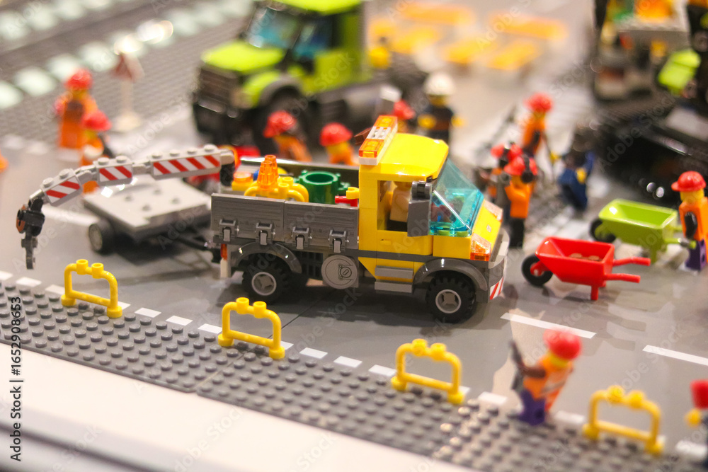 Naklejka premium Colorful lego construction scene with truck and workers