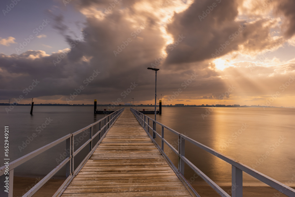Fototapeta premium A long, beautiful pier at Krautsand on the Elbe.