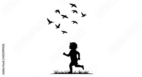 Silhouette of a child running towards a flock of birds in flight.
