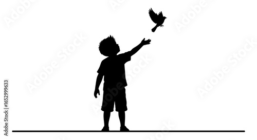 Silhouette of a boy releasing a bird, representing freedom and letting go.