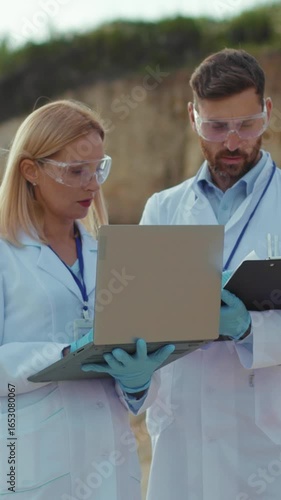 Researchers and scientists dedicatedly analyzing data accumulated in a field research setting
