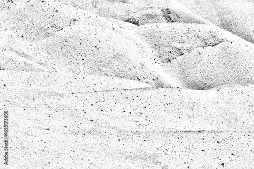 A monochrome image of the rugged, hilly texture of sandstone rocks formed by erosion.