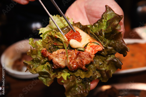 Korean bbq. ssam : eat pork wrapped in lettuce leaves