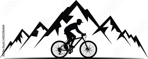 Silhouette of a mountain biker riding in front of jagged mountain peaks