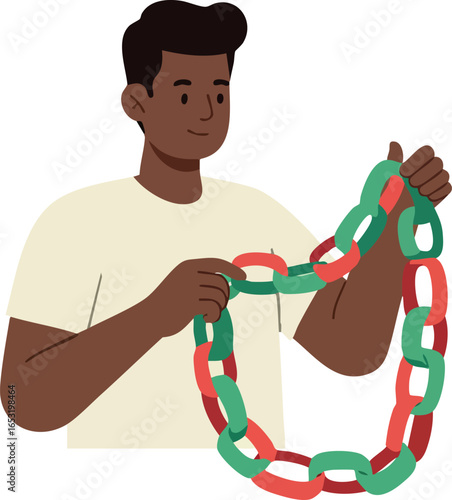 Young man holding red and green paper chain decoration for festive event celebration 