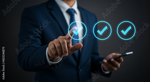 A businessman is using a smartphone to select a check mark icon, representing success, approval, and verification in a business or quality control context