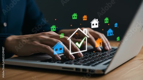 Person typing on laptop with house icons floating above the keyboard and a dark background scene view