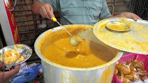 dalcha being mixed in big pot slow motion footage