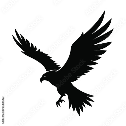 Black silhouette of a hawk in flight with wings spread bird