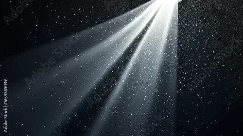 Radiant beams of light illuminate a dark space, glittering particles descend