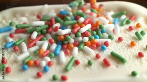 Colorful sprinkles on white ice cream