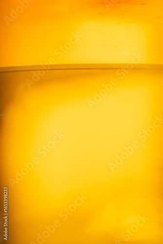 Golden beer close-up with bubbles in glass