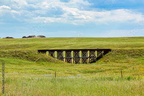 Summer Storm Clouds over the Abandoned Wooden Trestle of the Old Chicago and Northwestern Railroad on Highway 20 in Western Nebraska.