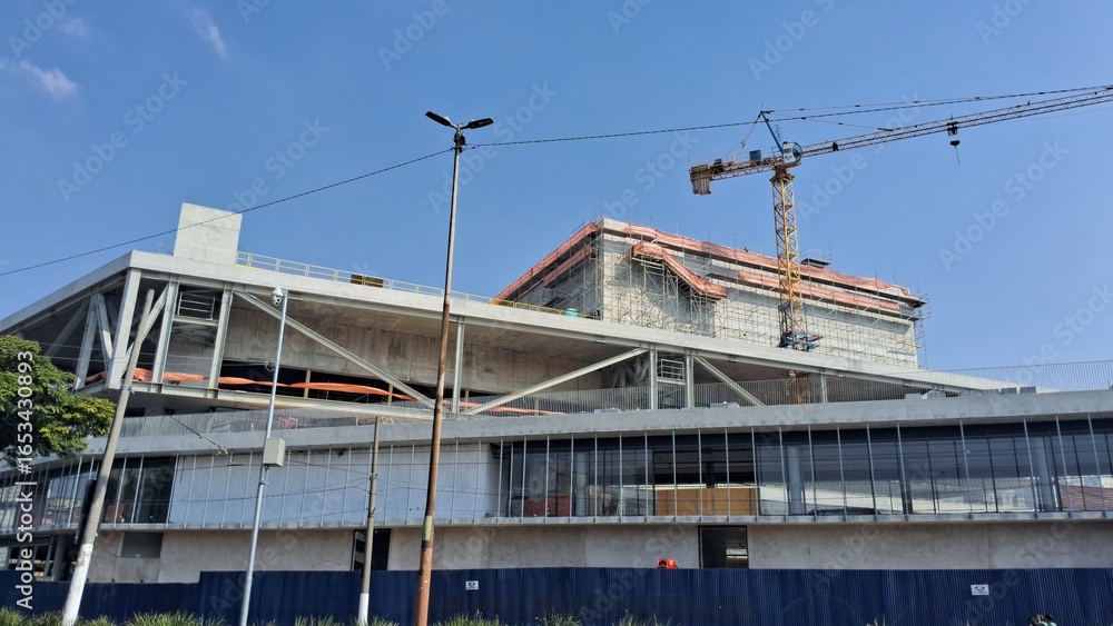 Construction site of a modern building with a crane in the background Construction site of a modern building with a crane in the background