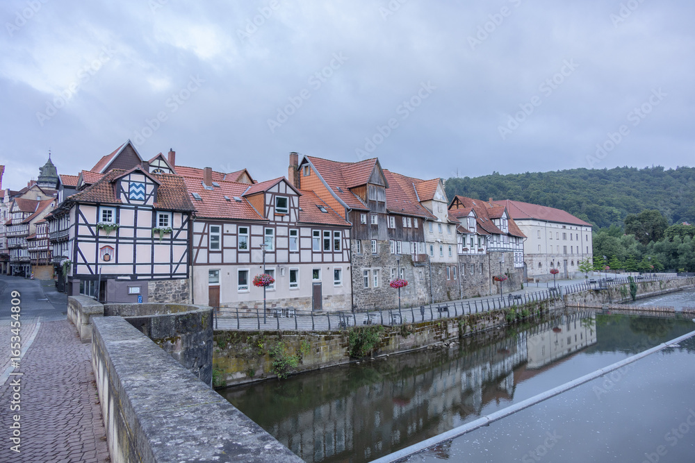 Obraz premium Traditional German half timbered houses with red roofs reflecting in calm river