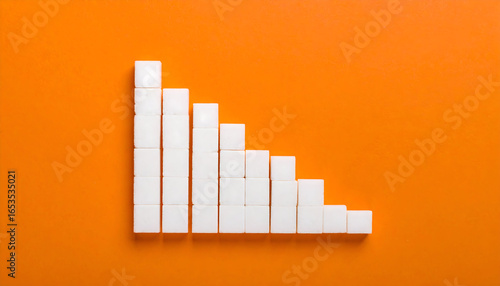 Descending Sugar Cubes Arranged In A Graph On A Bright Orange Background