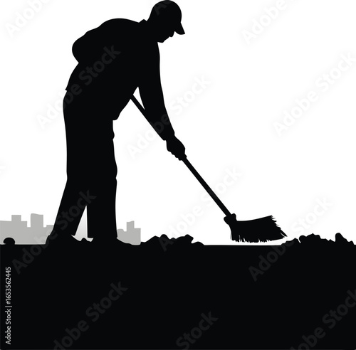 Silhouette of a worker sweeping trash with city skyline background