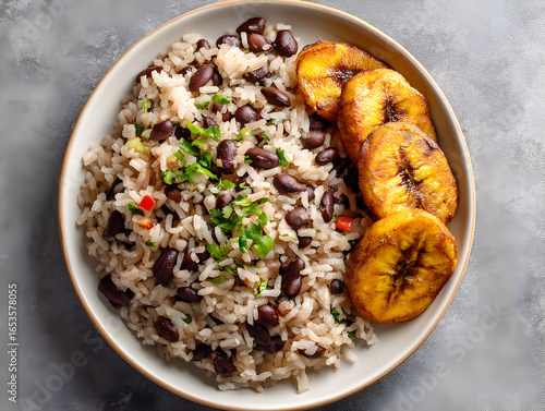 Fototapeta Naklejka Na Ścianę i Meble -  Overhead shot of moros y cristianos, a traditional cuban dish of rice and black beans with plantain