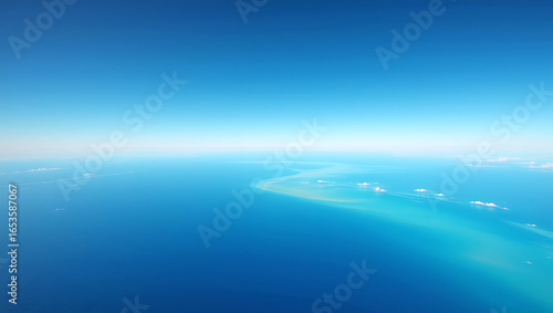 Beautiful abstract blue sea and sky with clouds reflection on the water at the horizon