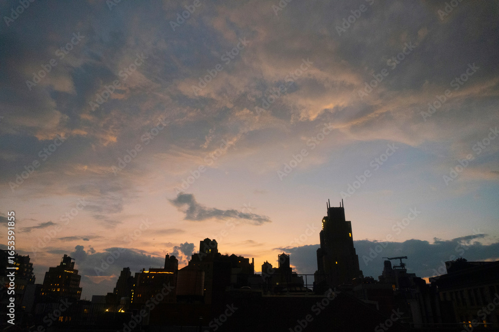 Fototapeta premium beautiful sunset over the buildings of a city