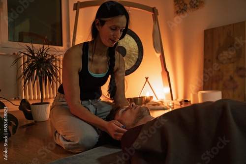 Quadro em tela Thai yoga massage, mindfulness, masseuse focusing on energy in palms and holding
