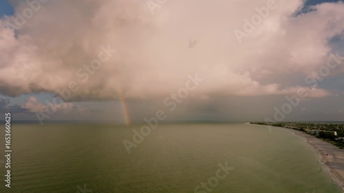 A rainbow from cloud to the horizon in full view off the coast of Anna Maria Island on Florida's gulf coast.