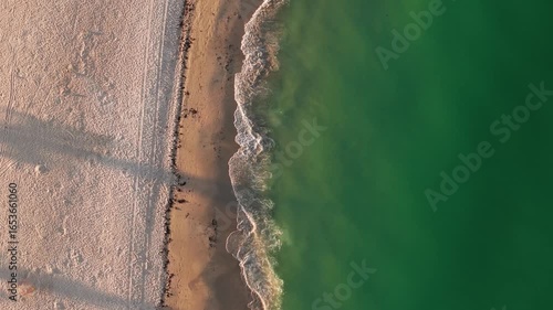 Small waves gently lap the shoreline of Anna Maria Island on Florida's gulf coast.