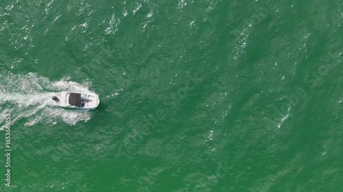 Overhead view of a boat navigating the waters of Florida's gulf coast.