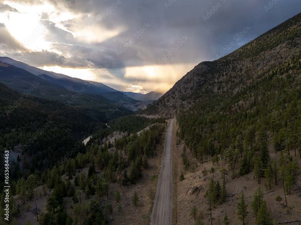 Fototapeta premium Scenic Winding Road Through Forested Mountains at Sunset in BC, Canada