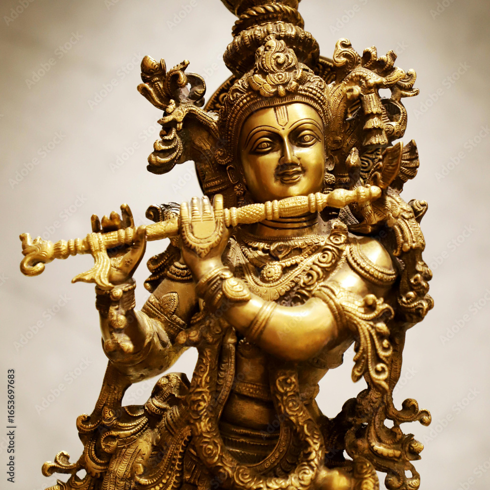 Fototapeta premium Lord Krishna idol - gold and copper finish - holding flute