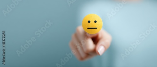 A neutral expression on a finger, with soft focus and gentle touch, communicating ambiguity.