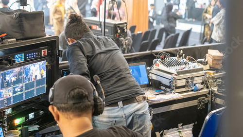 Canvastavla Backstage production team operating broadcast monitors and audio mixer during live event to manage video, sound, and recording
