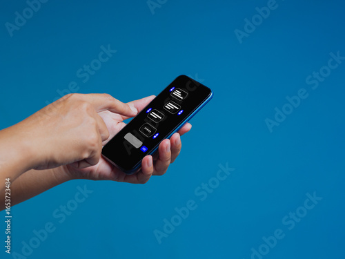 Wallpaper Mural Hand using smartphone with chatbot interface on blue background showing AI messaging and communication. Torontodigital.ca