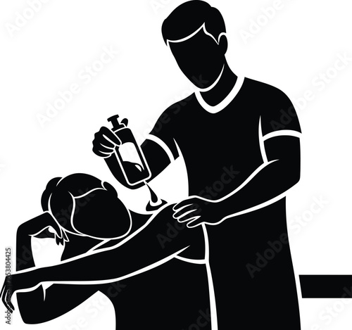 Therapist applies oil to patient's back during massage