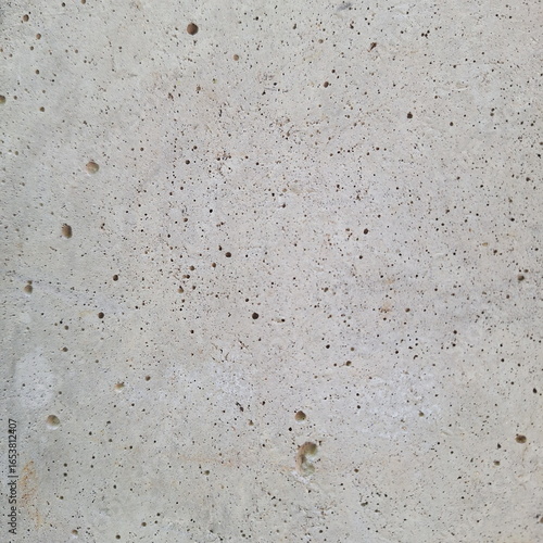 Close-up concrete wall texture with porous rough surface pattern