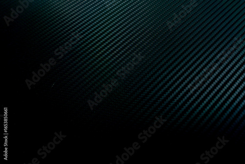 close-up of a carbon fiber pattern, black abstract background