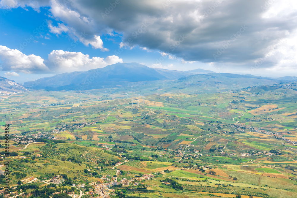 Obraz premium panoramic view of summer season landscape from above of beautiful valley with green fields and blue sea coast. Aerial view with amazing coastline hills and mountains.